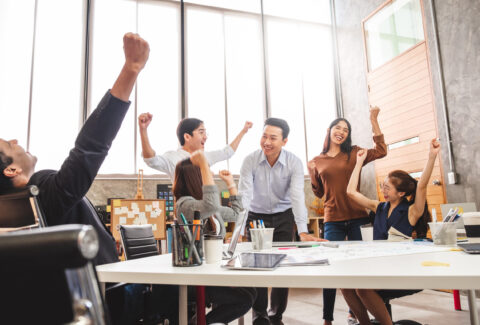 Business people smile and raise hands up, feeling happy, complet