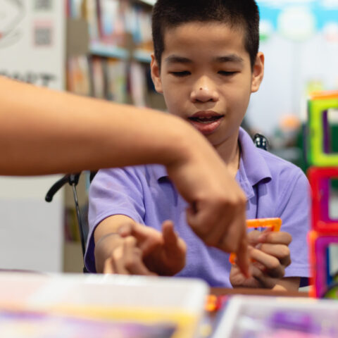 Disabled,Child,On,Wheelchair,Is,Interested,In,Skills,Development,Toys