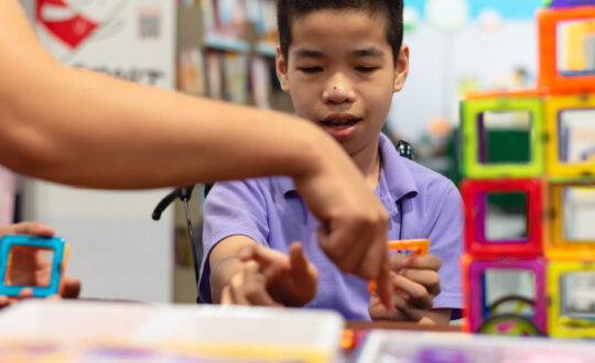 Disabled,Child,On,Wheelchair,Is,Interested,In,Skills,Development,Toys