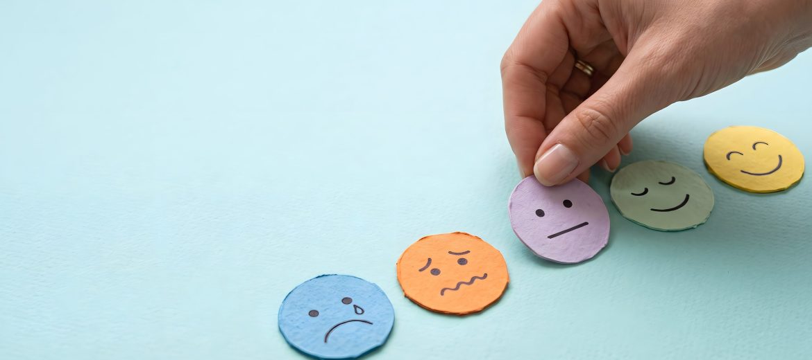 Hand placing a purple neutral emotion face icon on a blue background