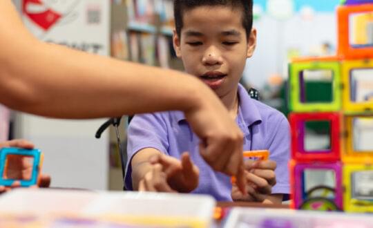 Disabled,Child,On,Wheelchair,Is,Interested,In,Skills,Development,Toys